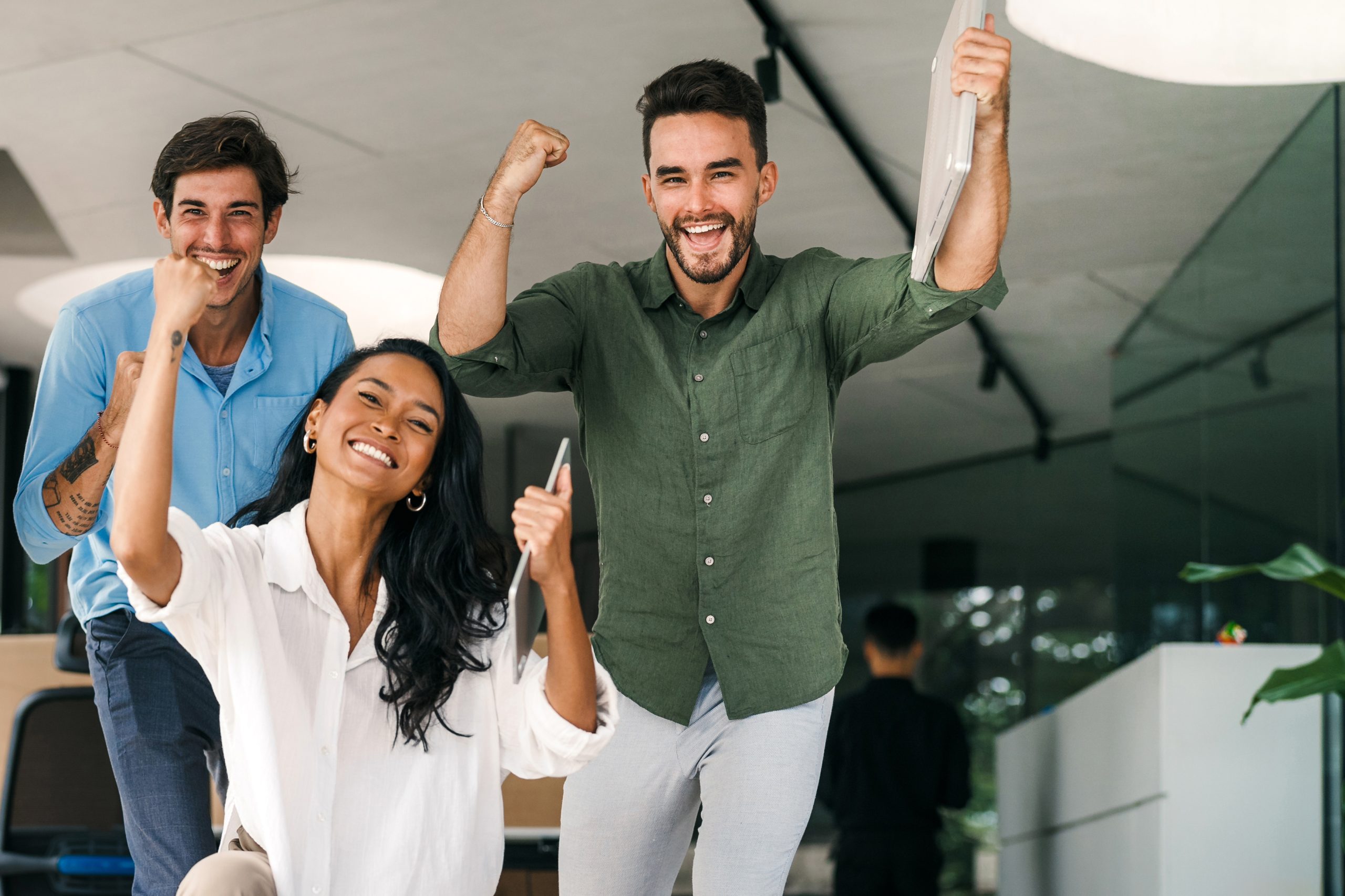 overjoyed young multiethnic colleagues celebrating shared corporate success or goal achievement overjoyed young multiethnic colleagues celebrating shared corporate success or goal achievement